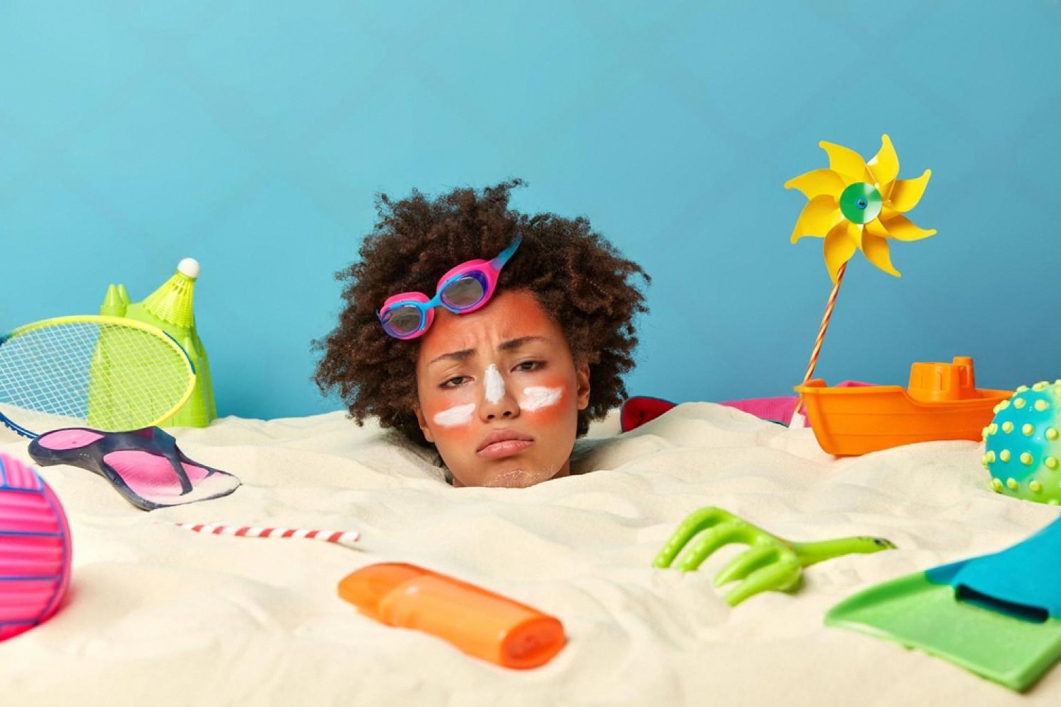 Woman with sunscreen on cheeks looking tired, showing sun-related dull skin in the UAE